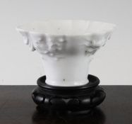 A Chinese Dehua blanc-de-chine libation cup, 17th / 18th century, modelled in relief with a crane