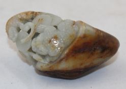 A Chinese pale celadon and russet jade pebble carving, 19th/20th century, carved in open work with