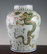A Chinese Wucai `dragon` vase, Transitional period, 17th century, of squat baluster form, painted