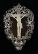 A Continental white metal mounted holy water stoup, with a carved ivory figure of Christ, 13.75in.
