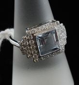 An 18ct white gold, aquamarine and diamond cluster ring, with central square cut aquamarine and