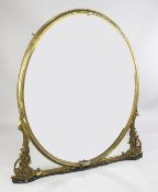 A Victorian gilt and gesso overmantel mirror, with oval plate glass and scrolling corner brackets,
