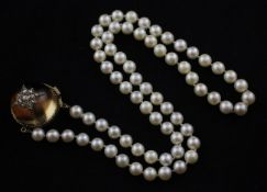 A single strand cultured pearl necklace with gold and diamond set domed rock crystal? set clasp,