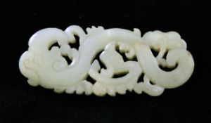 A Chinese pale celadon jade plaque, 18th / 19th century, carved in archaistic style as a stylised