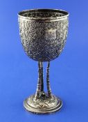 A late 19th/early 20th century Chinese silver goblet, extensively embossed with bamboo leaves, on