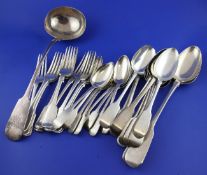 Thirty one items of George IV and later silver fiddle pattern flatware, some with engraved crests or