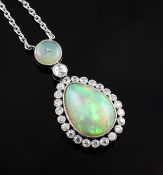A platinum, white opal and diamond pendant necklace, set with pear shaped opal bordered with