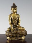 A Sino Tibetan gilt bronze seated figure of Buddha, 18th / 19th century, seated with his legs