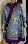 A Chinese embroidered silk lady`s robe, late 19th / early 20th century, decorated with a dragon