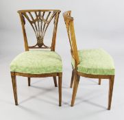 A pair of neo-classical Swedish ash side chairs, the backs decorated with ear or corn and swags,