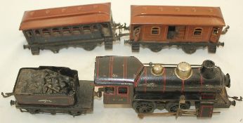An early 20th century Bing 0-4-0 tinplate locomotive, with coal tender and two passenger wagons