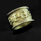 A 17th century German Jewish silver gilt betrothal ring, worked on a textured surface with floral