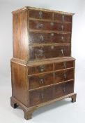 An early 18th century walnut chest on chest, fitted two short and three long drawers above four