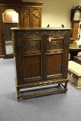 A 17th century style oak cupboard, with two panelled doors, 3ft 8in.