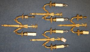 A set of four Louis XVI style ormolu wall lights, with twin scrolling branches and ribbon crests,