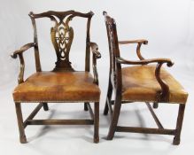 A pair of Chippendale style mahogany elbow chairs, with pierced vase shaped splats, studded brown