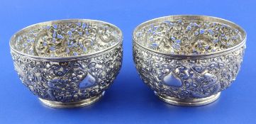 A pair of late 19th/early 20th century Chinese pierced silver bowls, decorated with dragons, on
