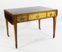 A Sheraton style library table, the leather top with gilt tooled and brown leather inset skiver