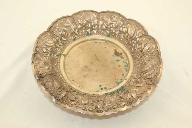 An Indonesian Yogya silver footed dish, early 20th century, the border pierced, embossed and