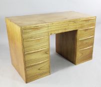 Robin Nance of St Ives. A mid 20th century kneehole desk, fitted with nine drawers with convex