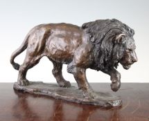 A 20th century patinated bronze model of a walking lion, unsigned, with founders stamped for