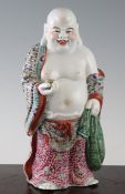 A Chinese famille rose enamelled standing figure of Budai, Republic period, the jolly figure