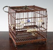 A Chinese bamboo, rosewood and ivory mounted bird cage, with four porcelain bird feeders, 19th