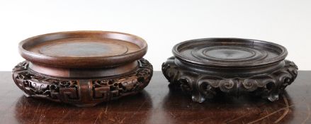 Two Chinese rosewood stands, late 19th / early 20th century, the first with ruyi head and scroll and