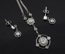 An 18ct white gold and diamond set suite of jewellery, comprising a target drop pendant necklace and