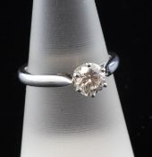 A platinum set solitaire diamond ring, the round brilliant cut stone weighing approximately 1.