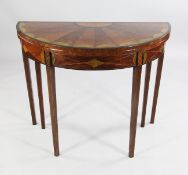 A George III mahogany satinwood and green stained marquetry inlaid demi lune folding card table, the