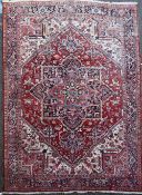 An Iranian Heriz carpet retailed by Liberty, with large central foliate medallion in a field of