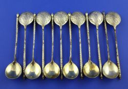 A set of twelve 19th century Russian 84 zolotnik silver gilt spoons, with spiral handles and bowls