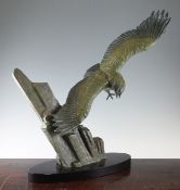 A French Art Deco patinated bronze figure group modelled as an eagle in flight, on an oval