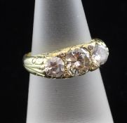 A Victorian style 18ct gold and three stone ring set with a round cut diamond and flanked by two