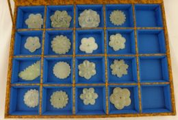 A collection of sixteen Chinese nephrite and bowenite jade flower garment ornaments, Yuan - Ming