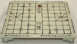 A Chinese blue and white weiqi board and pieces, 20th century, painted with characters to the