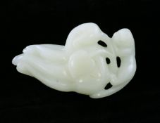 A Chinese white jade carving of a lion-dog crawling over a giant finger citron, 18th century, 7.