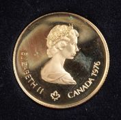 A cased Royal Canadian Mint 22ct gold proof 1976 Olympic $100 coin. with certificate.