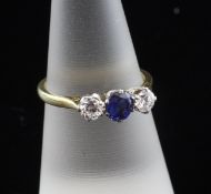 An 18ct gold and platinum, three stone sapphire and diamond ring, set with round cut stones, size