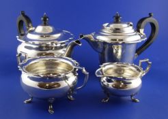 A George V matched four piece silver tea set, of circular form, with shaped rim, on cabriole legs,