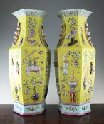 A large pair of Chinese yellow ground hexagonal vases, 19th century, each painted in famille rose