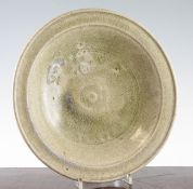 A Chinese celadon dish, Song-Jin dynasty, with a green crackle glaze broad rim, with some mauve