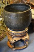 A 19th century Japanese bronze temple gong, on traditional circular stand with four scroll legs