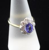 An 18ct gold, sapphire and diamond cluster ring, of oval form, with an estimated sapphire and