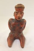 A Pre-Columbian Nayarit red slip decorated pottery seated figure of a woman, c.300AD, 8.9in.