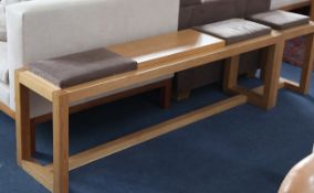 A De La Espada light oak bench, with part upholstered pad seats, together with a matching stool