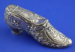 A late 19th century continental white metal table snuff box, modelled as a shoe and decorated with
