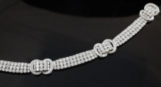 An attractive 18ct white gold and diamond set bracelet, with three ""buckle"" motifs and set with
