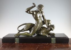 P. Hugonnet. A French Art Deco bronze group of a warrior fighting a panther, on black marble